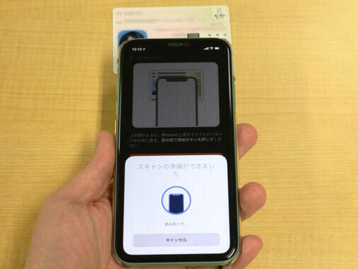 iPhoneにマイナンバーカードを読み取らせている様子