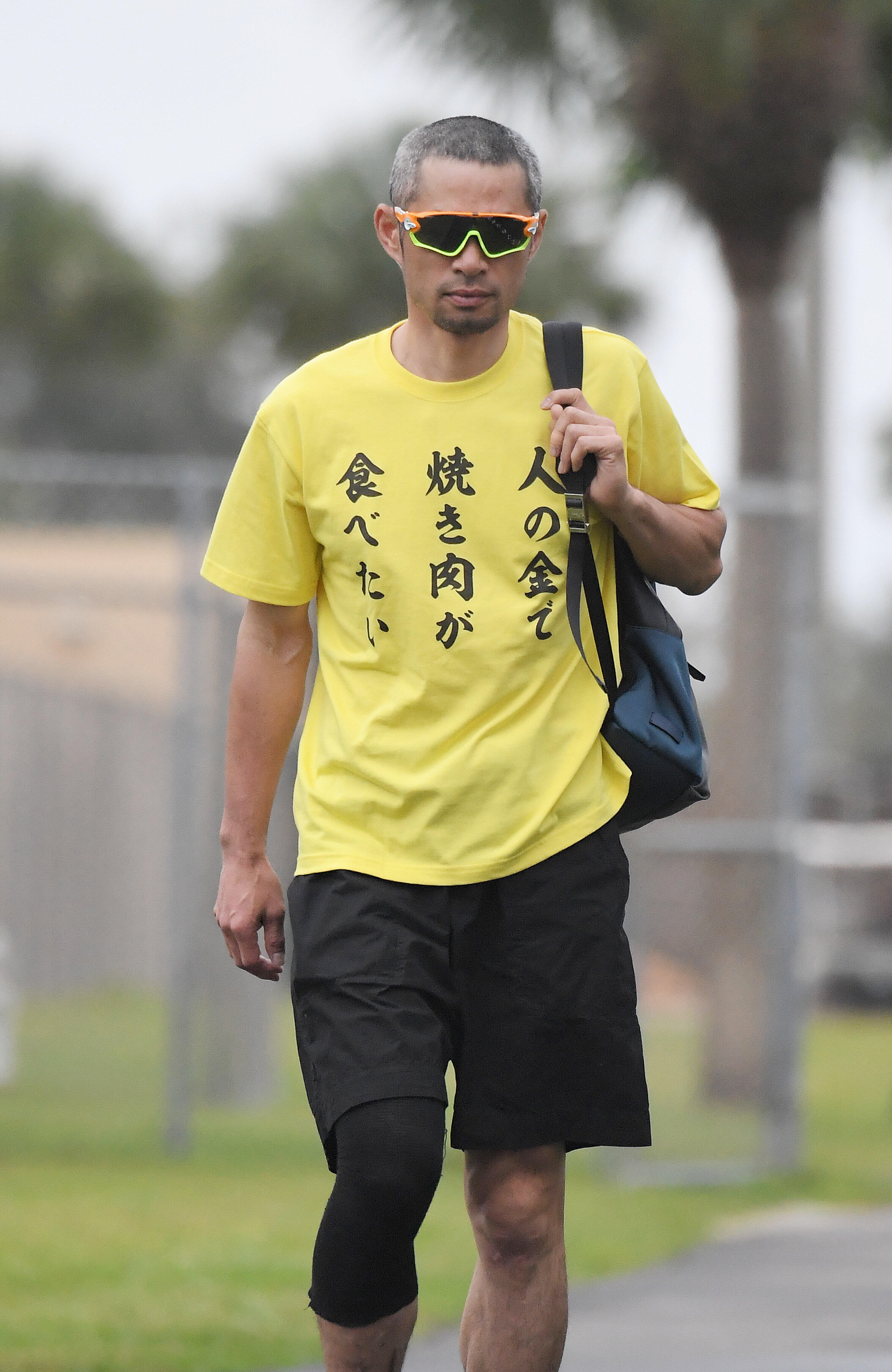 「人の金で焼き肉が食べたい」と書かれたＴシャツを着てキャンプ地に入るイチロー氏（写真：アフロ、2017年2月22日撮影）