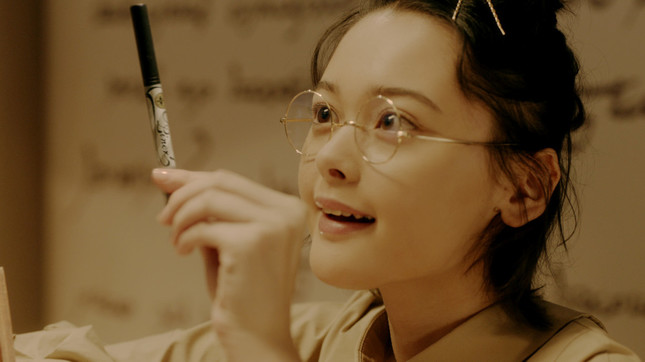 リキッドアイライナーを手に取った少女が喜ぶシーン