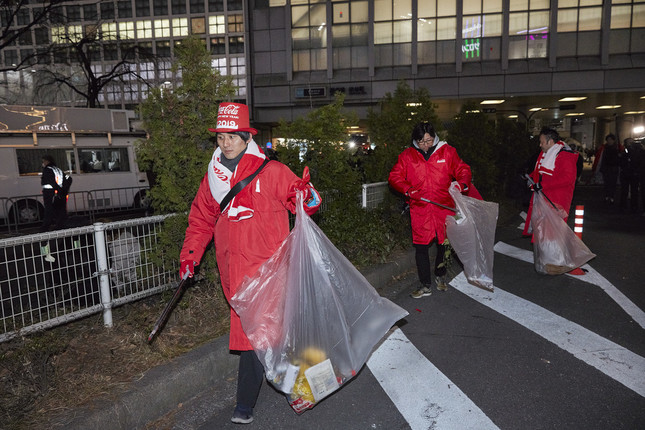 カウントダウン終了後、ゴミ拾いを行う日本コカ・コーラの有志社員