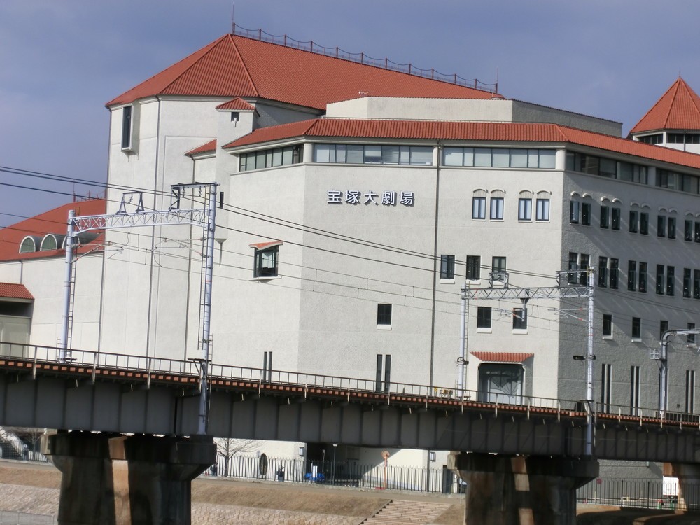 阪急今津線の軌道近くにある宝塚大劇場。建物背後に宝塚駅がある