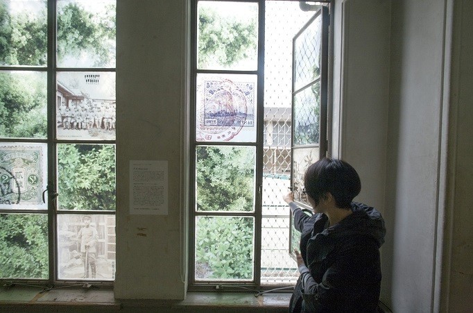 展示会場の窓に、日本人が住んでいたことを示すウバメガシ、大田に住んできた人が日本に送った当時の郵便物や消印をコラージュした（写真　渡辺誠）