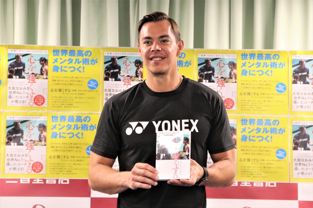 著書を手に持つサーシャさん