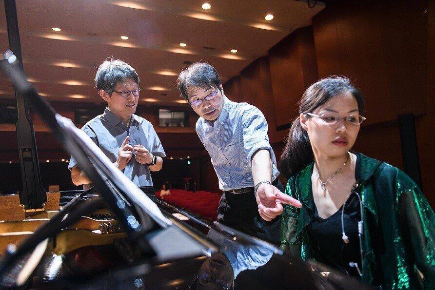 東京・赤坂にあるドイツ文化会館OAGホールで。韓国人作曲家のSeong-Joon Moon氏（左）と作品を演奏したピアニスト小坂絋未（オサカ・ヒロミ）氏（右）と最終演目の演奏打ち合わせをする小坂直敏氏。